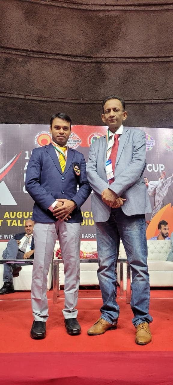 Coach medal stage pose