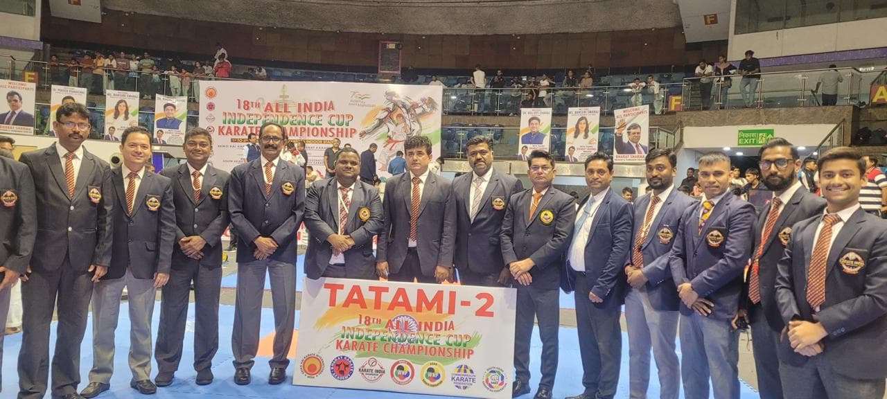 Tournament officials at the mat