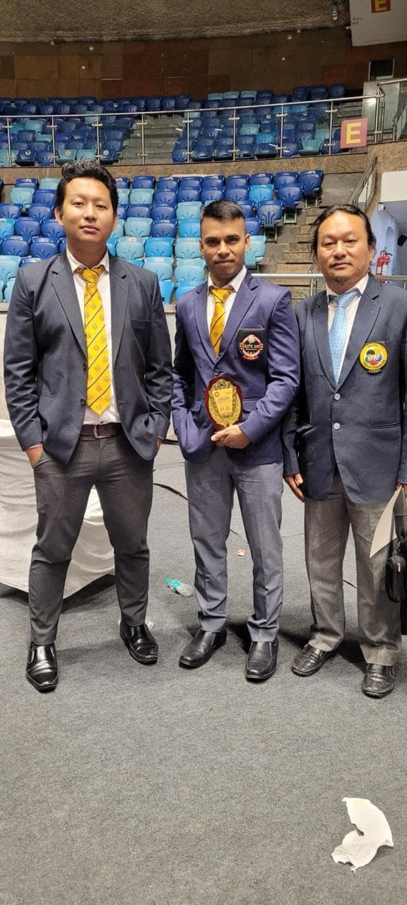 Officials and guests posing during a martial arts program