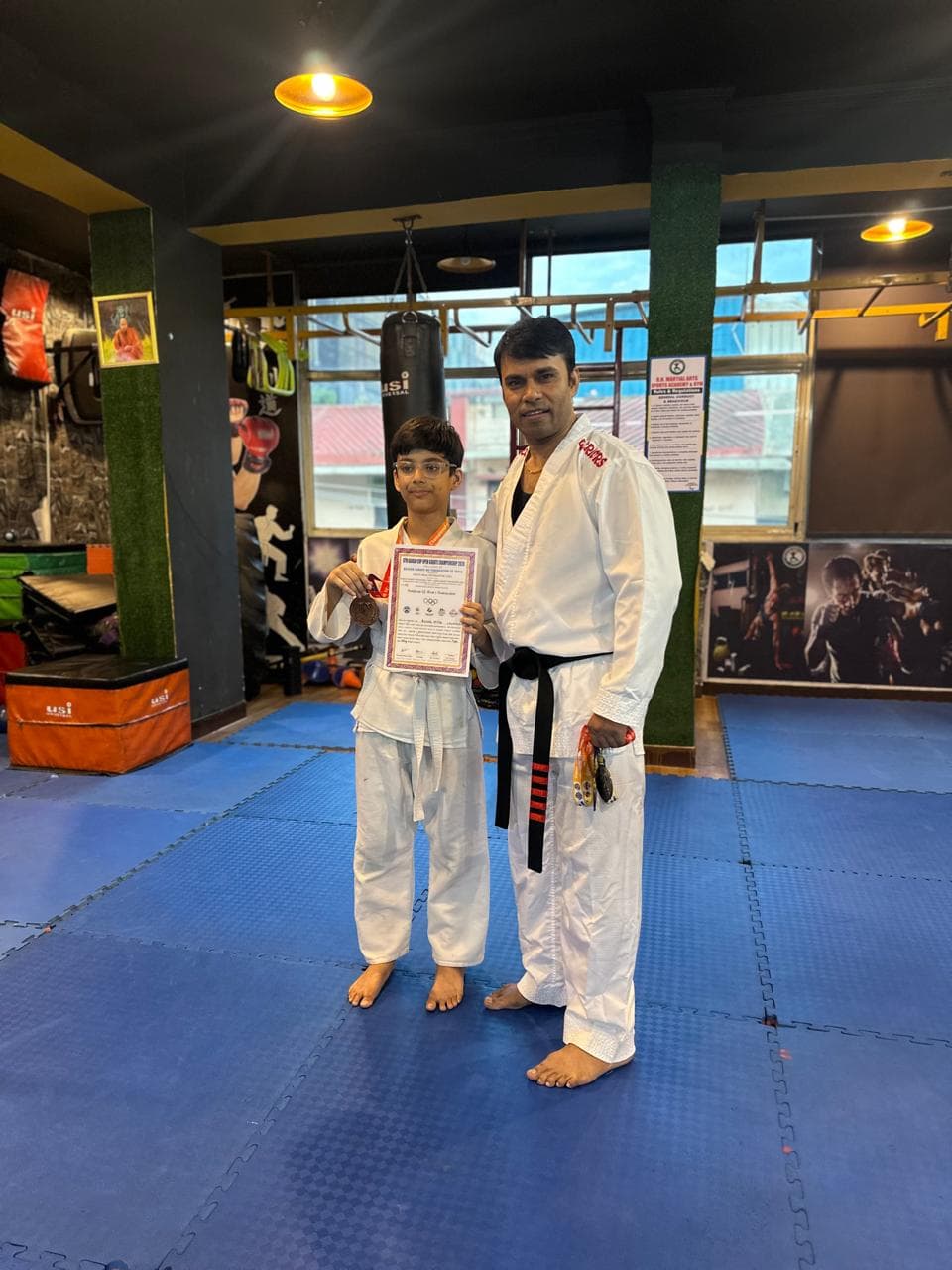 Martial arts student receiving recognition from the instructor