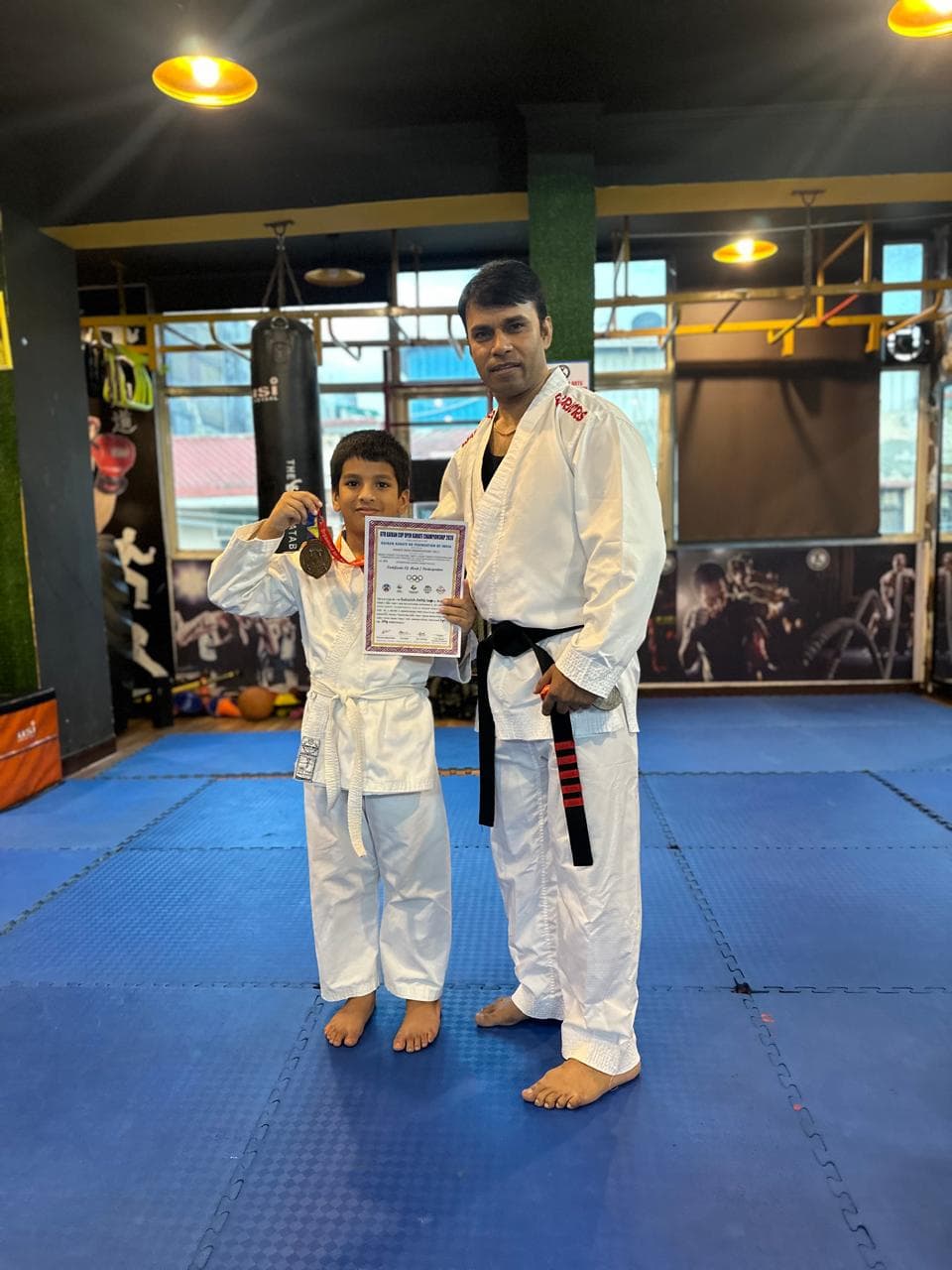 Young martial arts student proudly posing after class