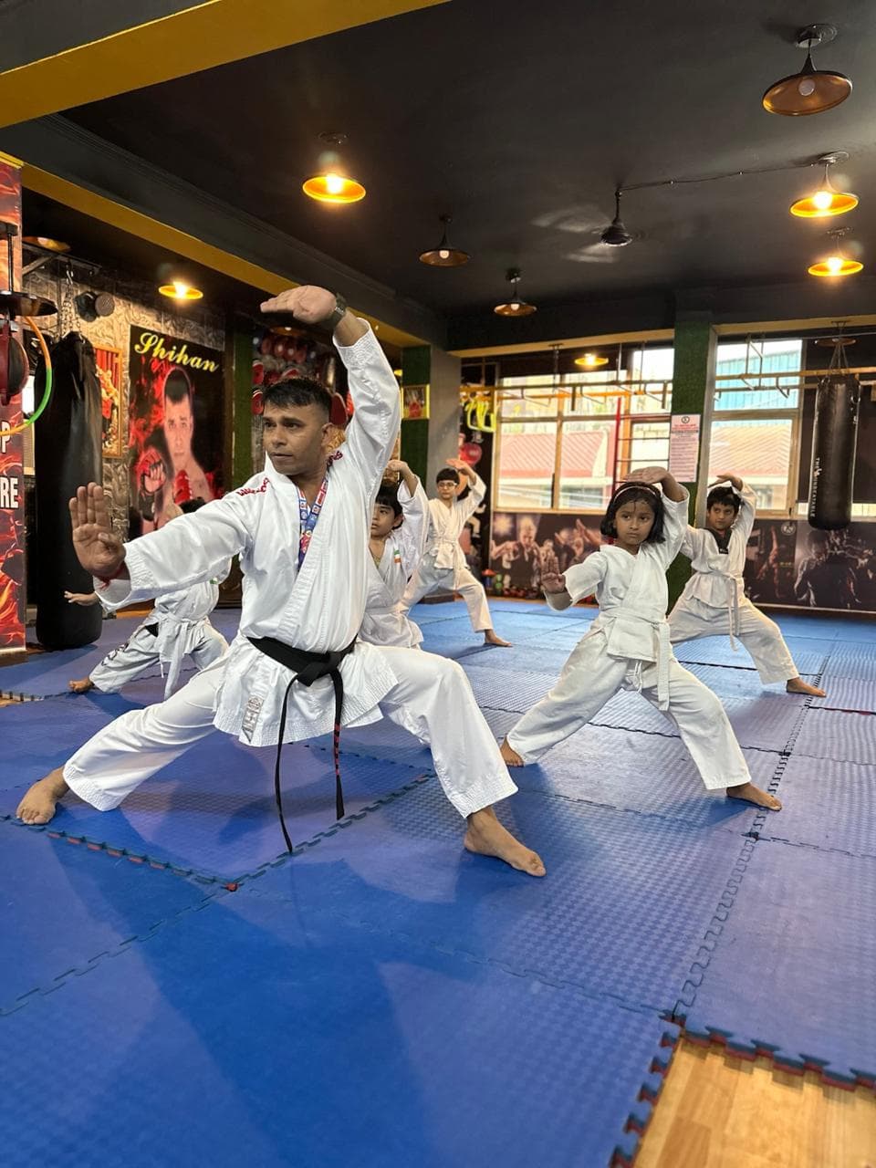 Students practicing synchronized martial arts movements