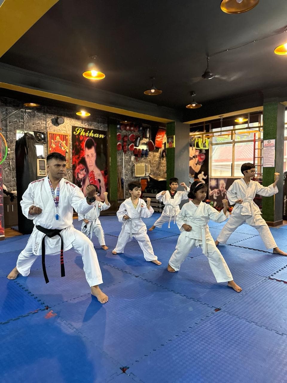 Children practicing martial arts blocking techniques